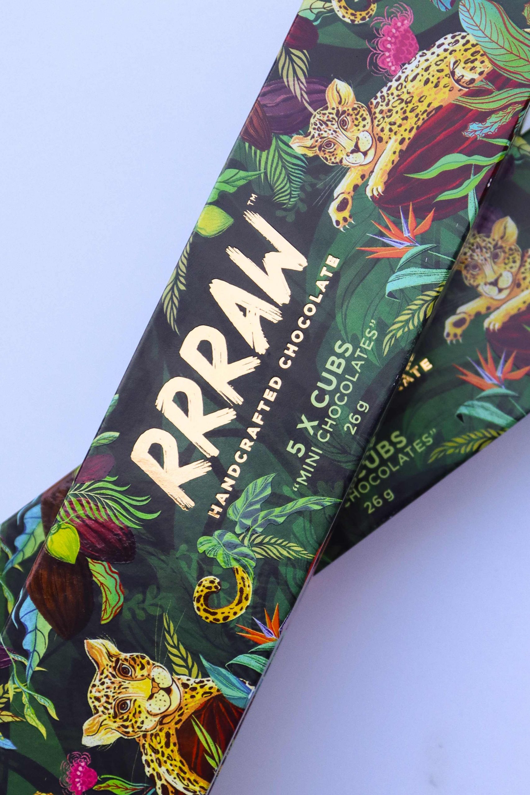 RRRAW cute leopard cubs hugging sweet cocoa beans in South African jungles chocolate bars packaging design photo